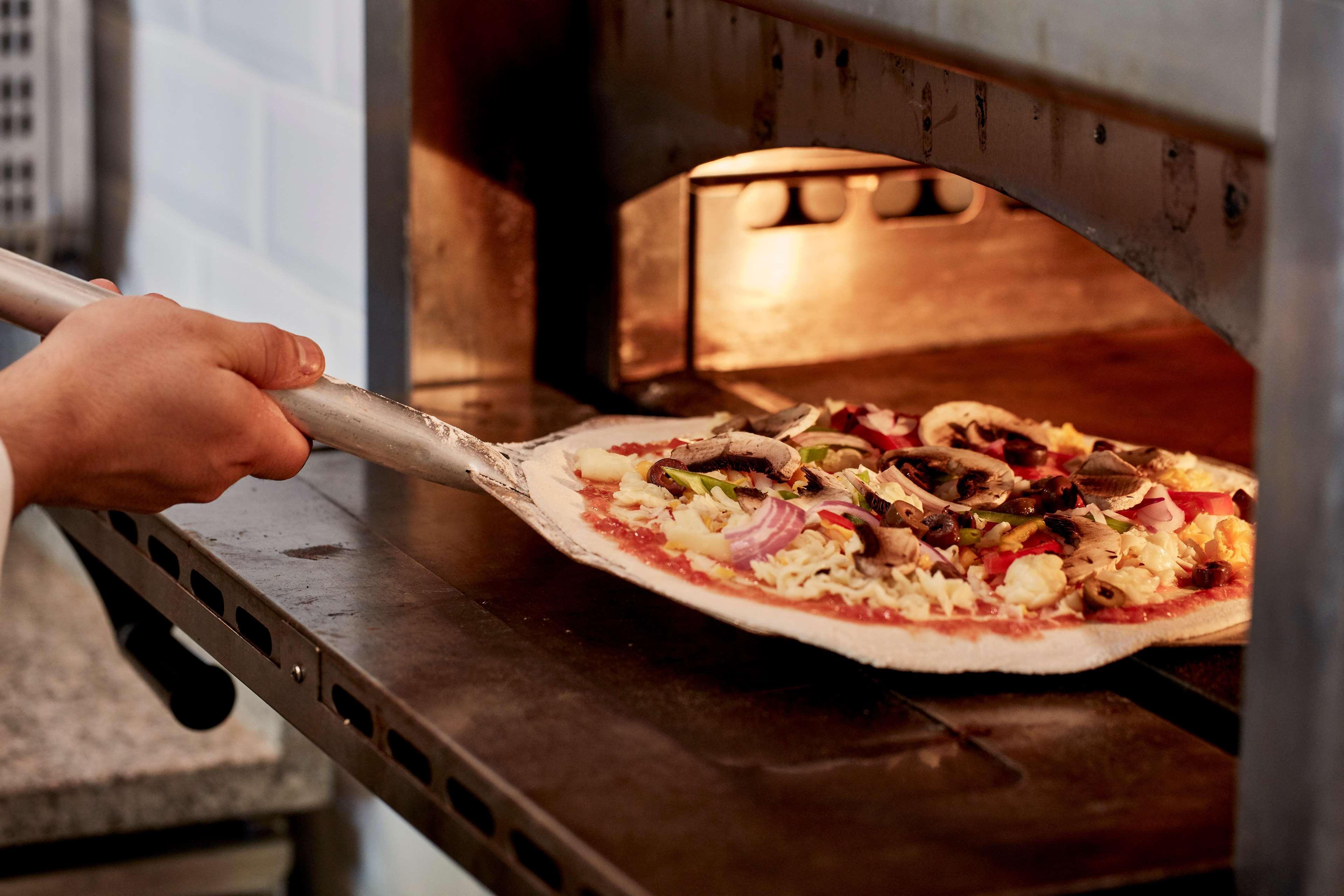 Kontokali Bay Resort & Spa Exterior foto Pizza being removed from a wood-fired oven